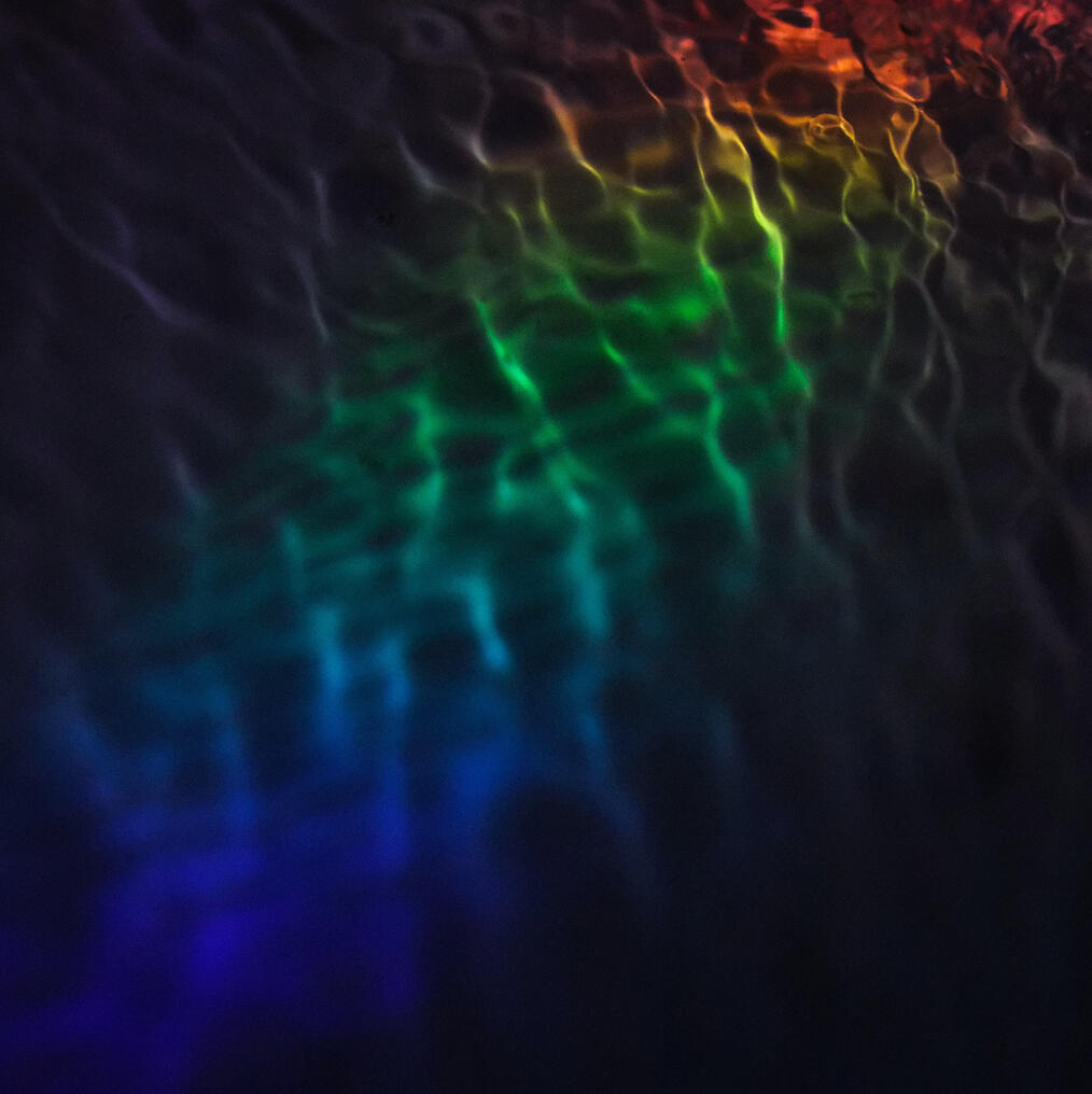 Water Ripples with prism light shining through it